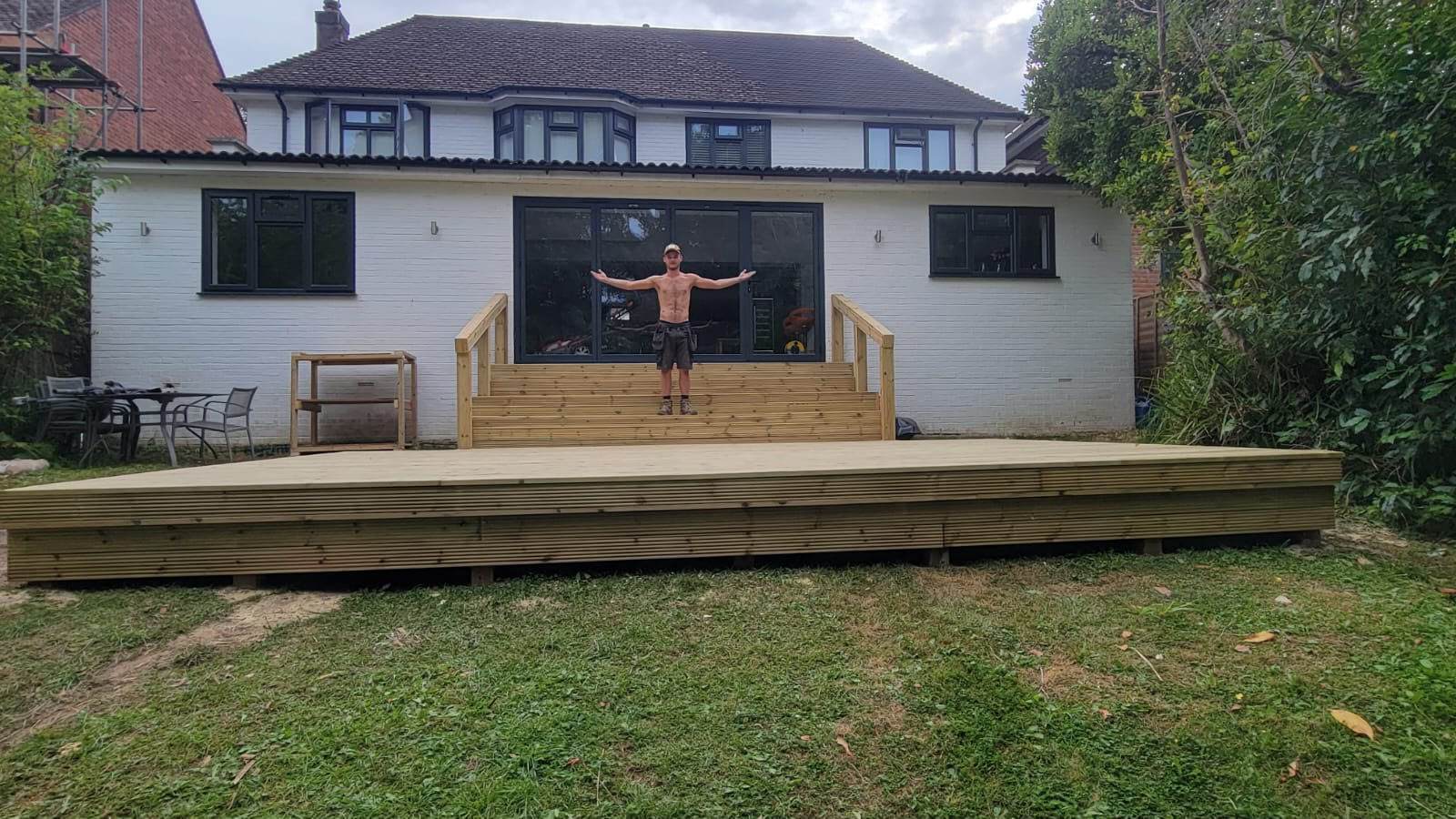 Finished timber garden deck with handrails, ready for handover
