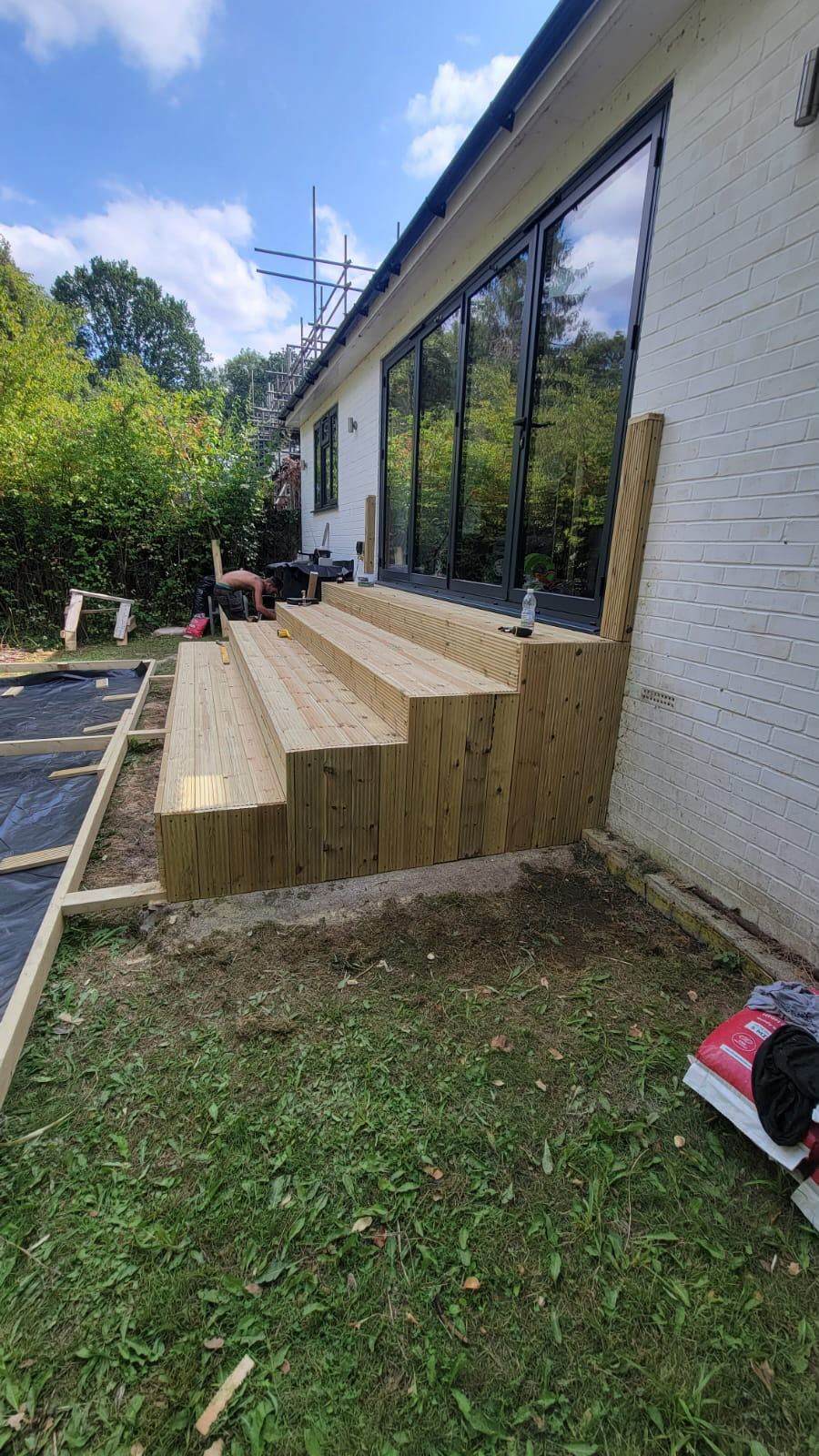 CN Construction team building a timber deck frame in a Surrey garden